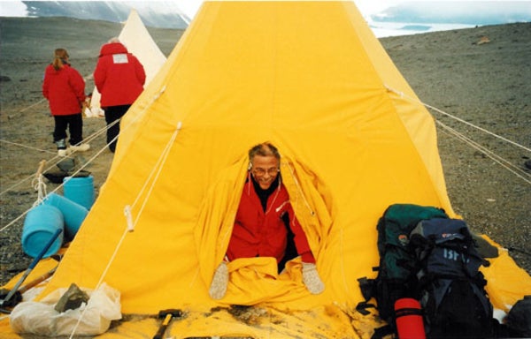 Warren Washington emerges from a tent. 