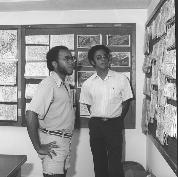 Warren and a fellow student looking at weather maps.