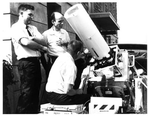John Firor, standing, second from left, around a telescope
