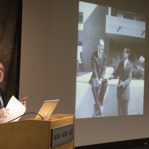 Professor Stuart 'Bill' Leslie presents his talk, 'A Different Kind of Beauty: I.M. Pei's Modernist Masterpiece,' featuring an archival photo of Walter Orr Roberts and I.M. Pei.