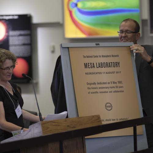 Sarah Ruth and Jim Hurrell unveil the design for the plaque which will be displayed at the Mesa Lab in honor of the re-dedication. 