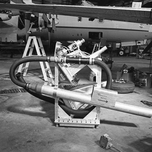 Instruments in a hangar in preparation for installation in the aircraft in the background.