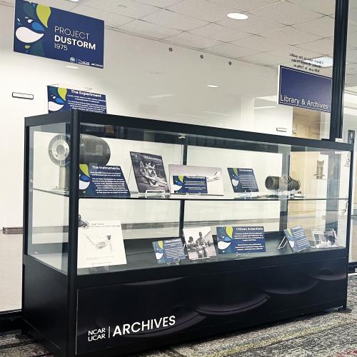 Exhibit case with instruments, photographs, and labels.