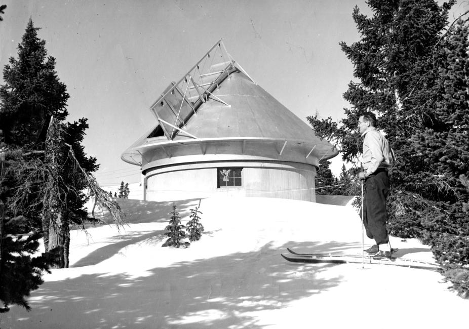 Walter Orr Roberts stands on skis in front of the Climax solar observatory.