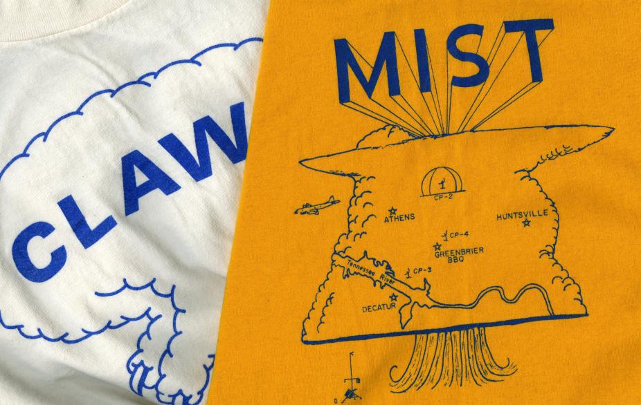 Two t-shirts with the front artwork visible. The shirts are from the CLAWS (Classify, Locate, Avoid Wind Shear) and MIST (Microburst and Severe Thunderstorm) projects. The designs on the shirts include the project acronyms and depictions of microbursts and observational equipment.