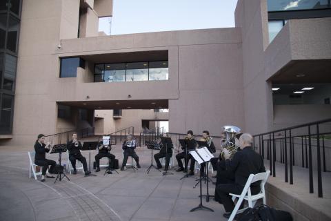 Members of the Boulder Philharmonic play in front of the Mesa Lab.