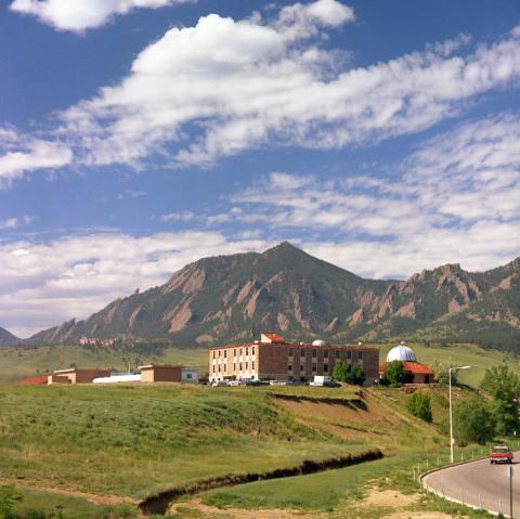 Newly constructed Astro-Geophysics building at the University of Colorado Boulder and the Sommers-Bausch Observatory. The Mesa Lab and the Flatirons are in the distant background.