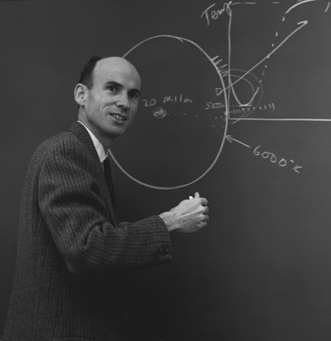 John Firor stands at a chalkboard, 1968.